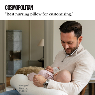 Man holding a baby with text about a best nursing pillow from a Cosmopolitian review