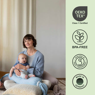 Woman holding a baby with Oeko-Tex and BPA-Free certification logos on the right bbhugme nursing pillow