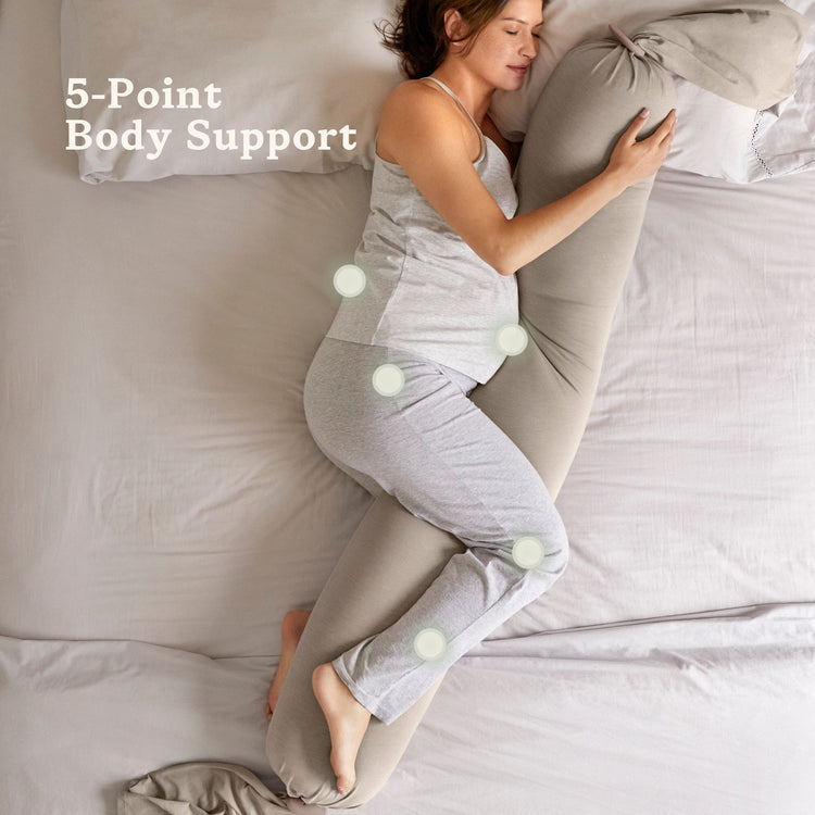 Woman using a bbhugme pregnancy pillow on a bed with text '5-Point Body Support'.