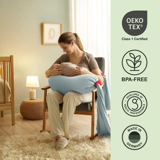 Woman holding a baby in a rocking chair with Oeko-Tex and BPA-Free certification logos on the right bbhugme pregnancy pillow